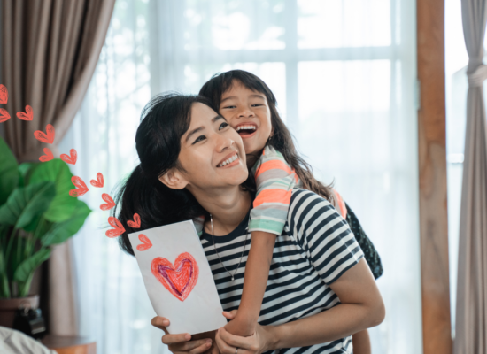 Daughter giving gift to mom for Mother's Day