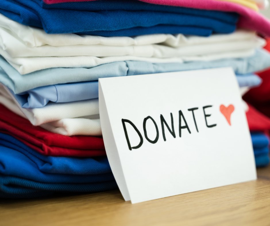 Folded preloved clothes with a donate card, ready for a doorstep donation pickup